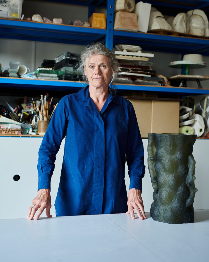 Photograph of artist with sculpture