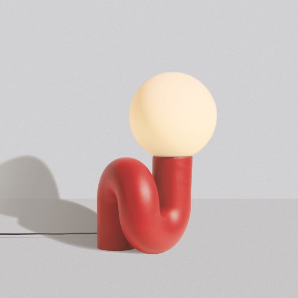 Red squiggly lamp on white backdrop