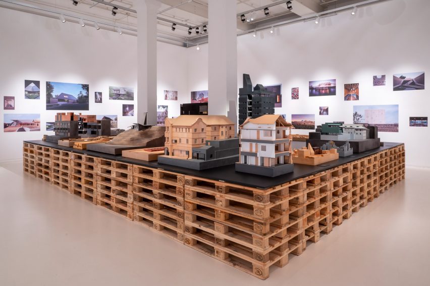 Architectural models on a table made of wooden pallets in Neri&Hu: Reflective Nostalgia exhibition