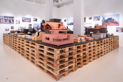 Architectural models on a table made of wooden pallets in Neri&Hu: Reflective Nostalgia exhibition