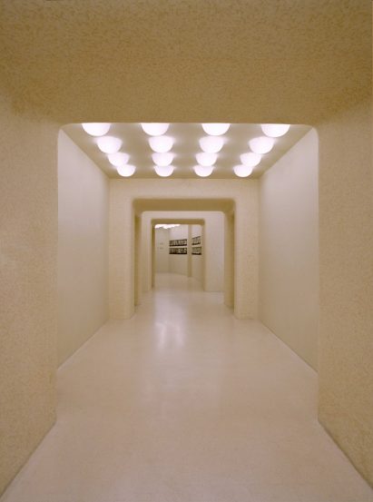 Mosaic-tiled hallway in store interior by Offhand Practice