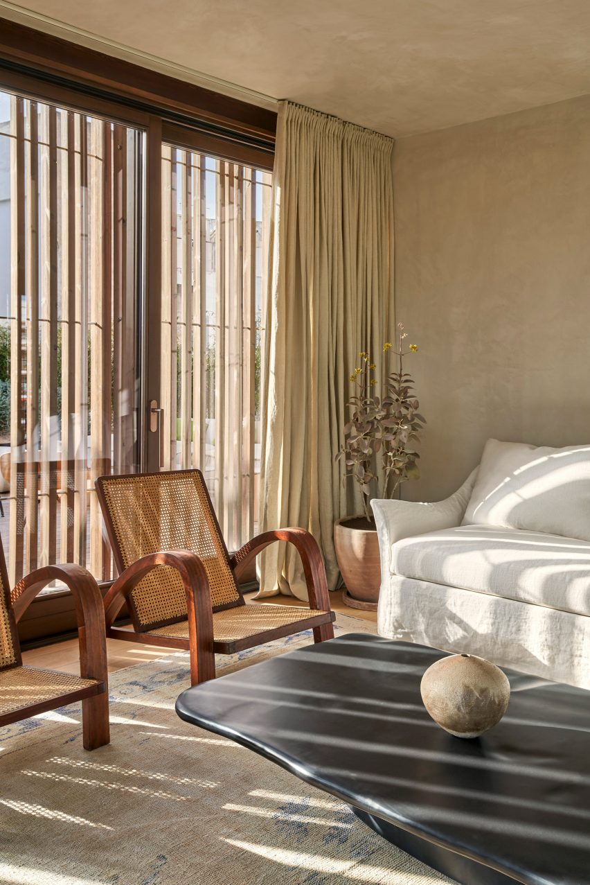 Wood screens and green courtyards define apartment block in Mallorca by OHLAB