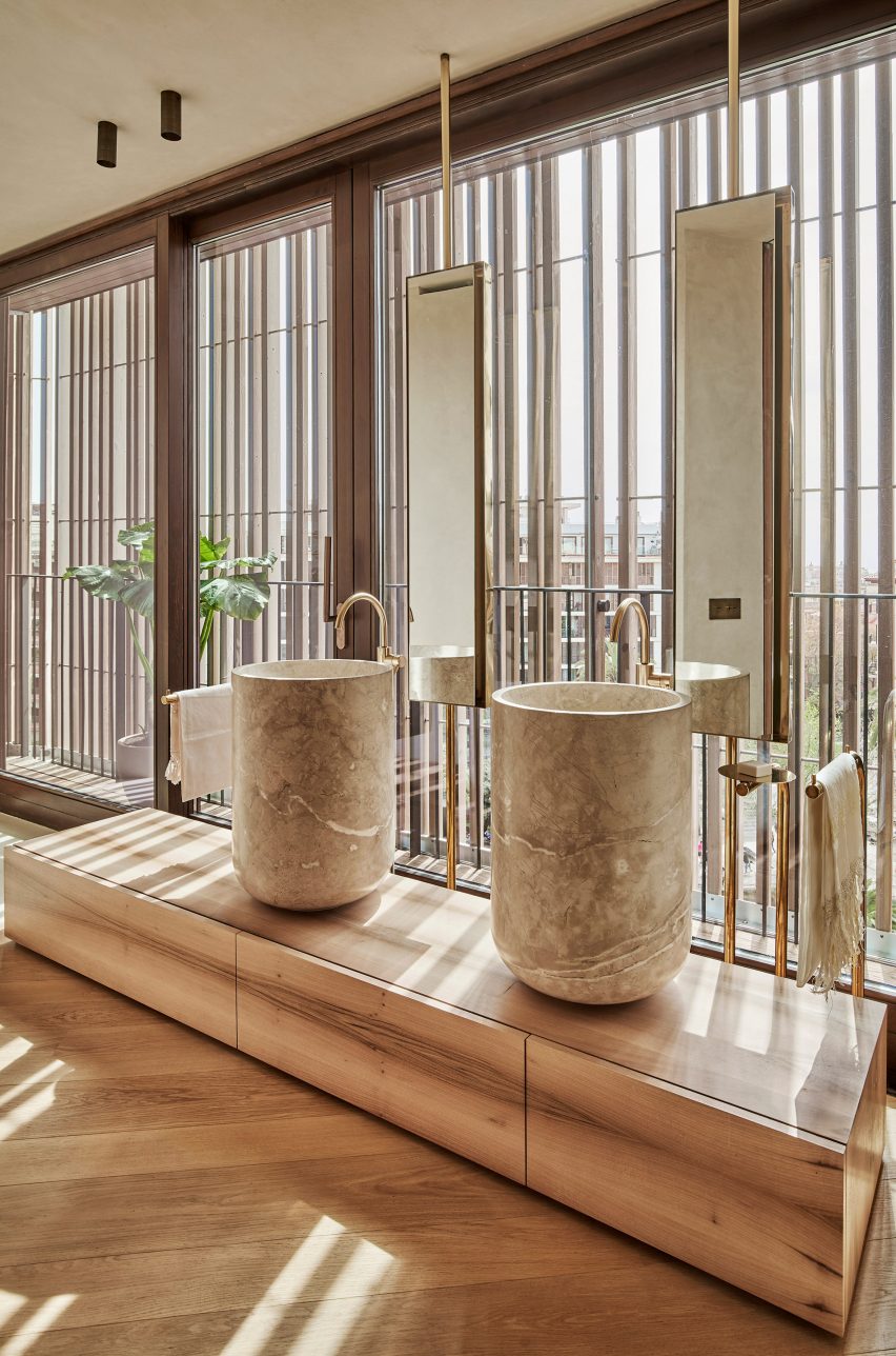 Wood screens and green courtyards define apartment block in Mallorca by OHLAB