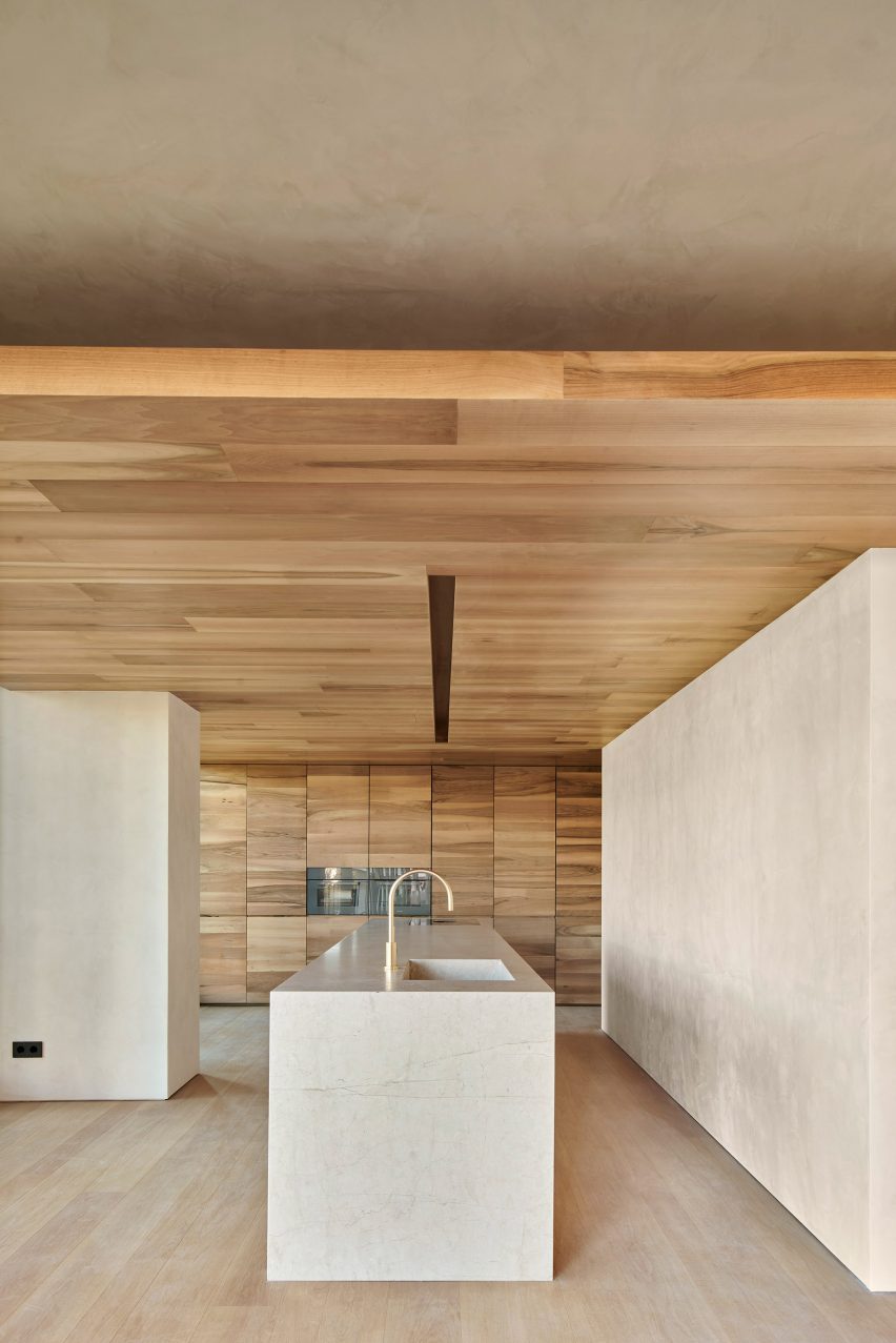 Kitchen with a stone island and timber ceilings and floors
