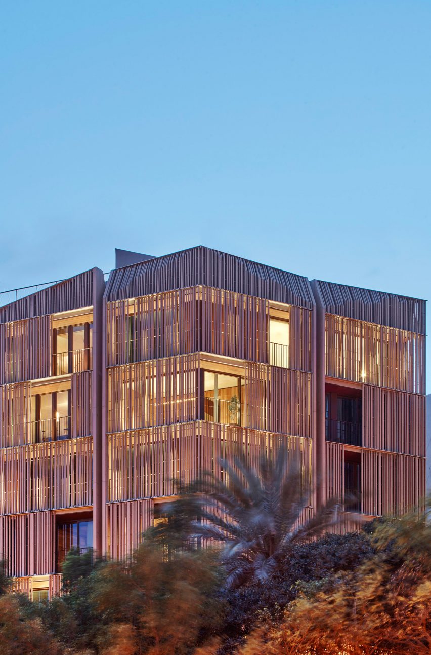Wood screens and green courtyards define apartment block in Mallorca by OHLAB