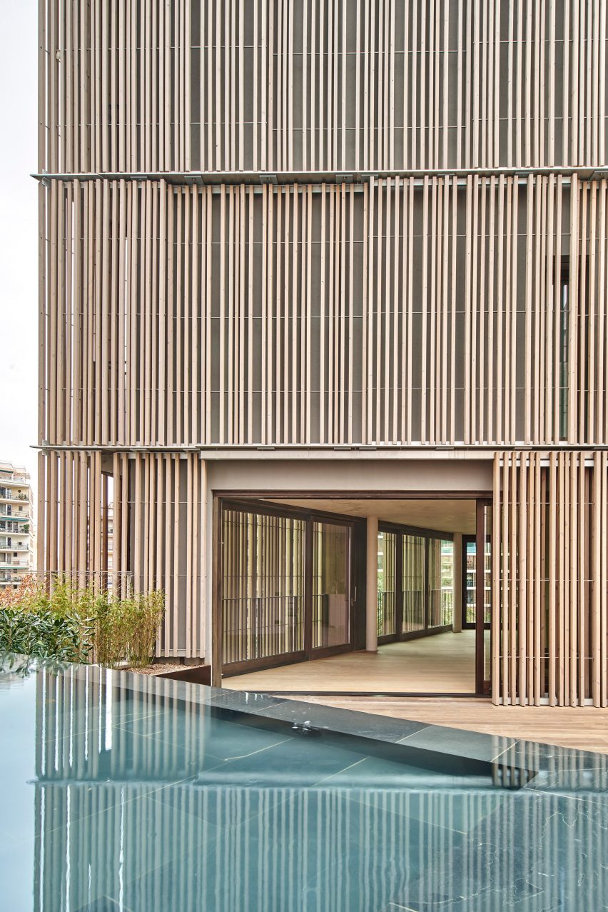 Wood screens and green courtyards define apartment block in Mallorca by OHLAB