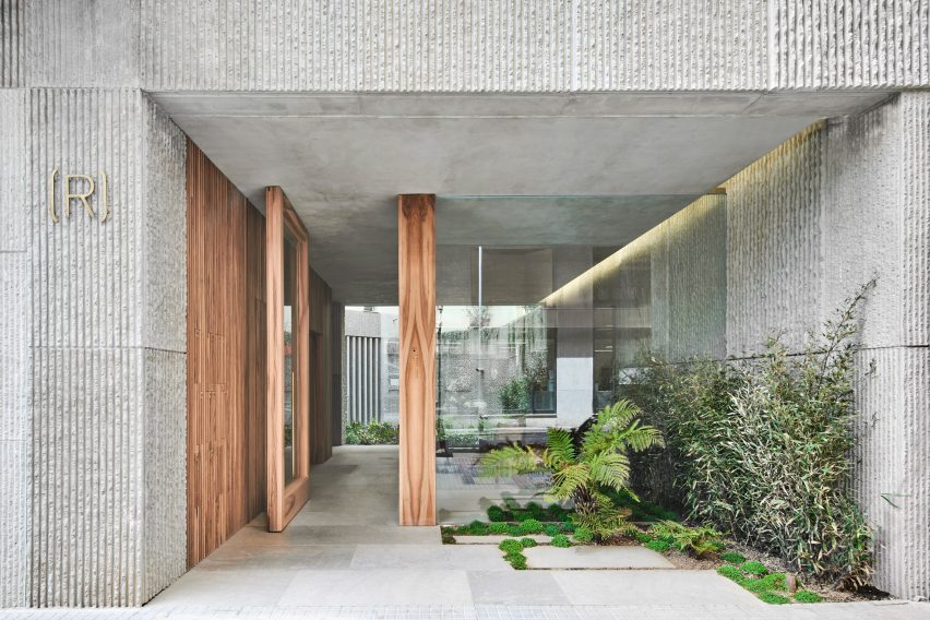 Wood screens and green courtyards define apartment block in Mallorca by OHLAB