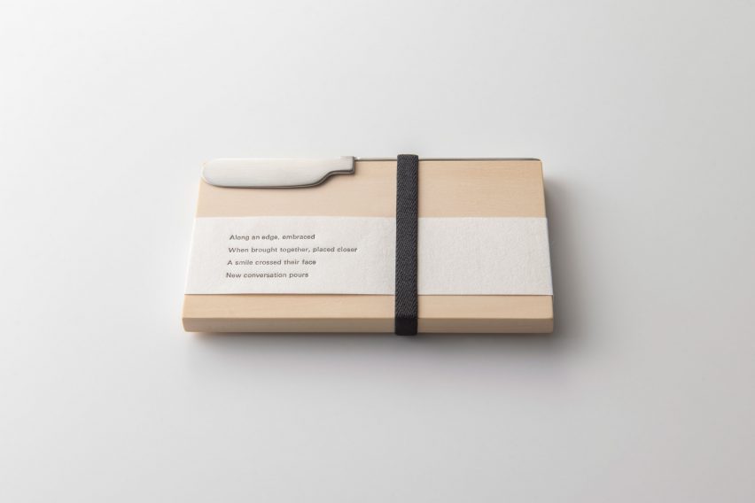 Oku knife packaged with a wood chopping board and poem printed on paper wrap