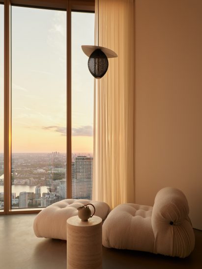 White sofa in front of floor-to-ceiling windows