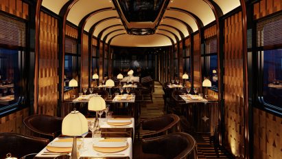 Interior view of the dining area, which has dimmed lighting, a mirrored ceiling and cosy seating