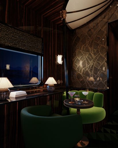 Close up of Bar Car interior with bright green seating and small round table with drinks sitting atop