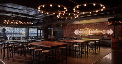 Interior of box seating at Geodis with guitar light mural