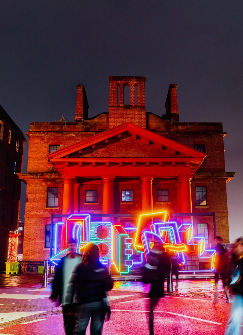 River Of Light colourful light installation by Camille Walala in front of a building at the Royal Albert Docks