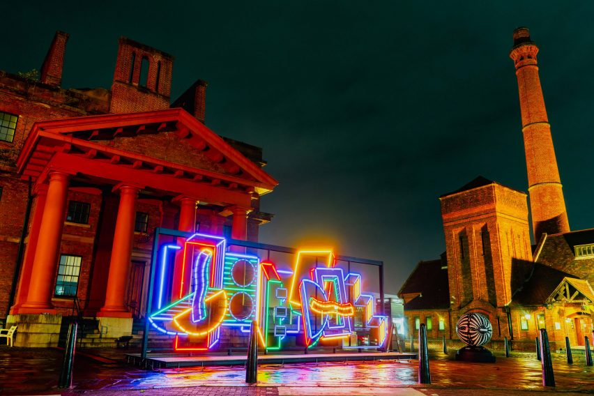 River Of Light colourful light installation by Camille Walala in front of a building at the Royal Albert Docks