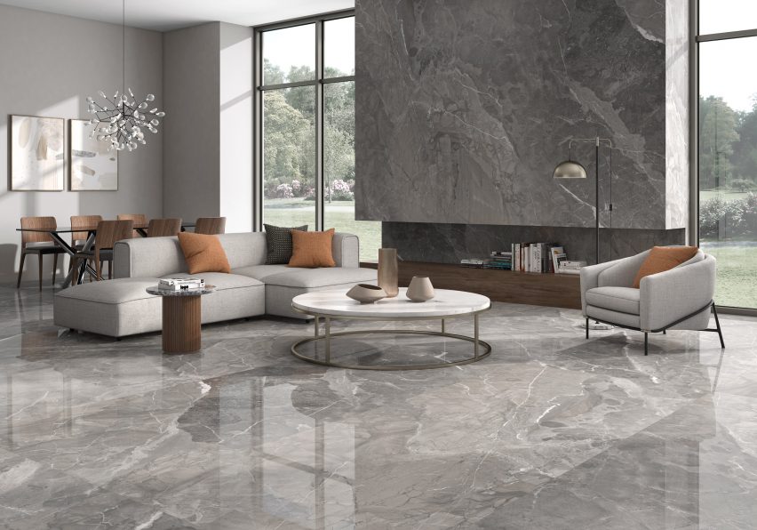 Living room with floor and fireplace mantle covered in grey tiles by Arklam