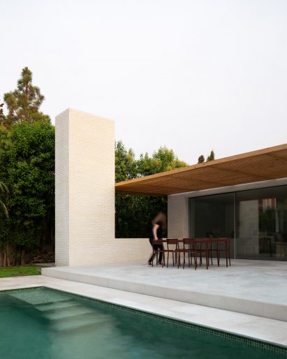 Exterior image of the rear of Brick House and its swimming pool