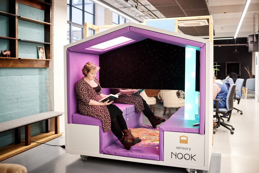 Photograph showing figure sitting inside sensory pod