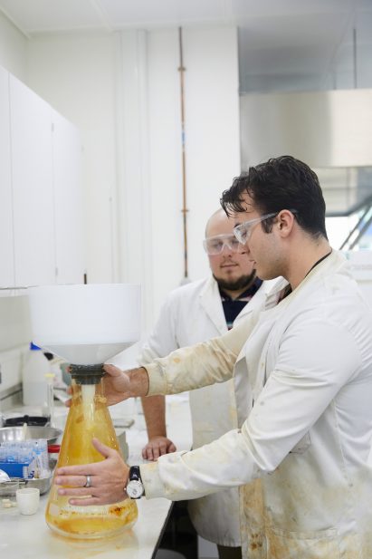 Sam Draper and Barney Shanks work on their concrete research inside a lab