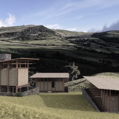 Three barn-like buildings an a green field