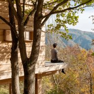 Person on terrace of wooden cabin