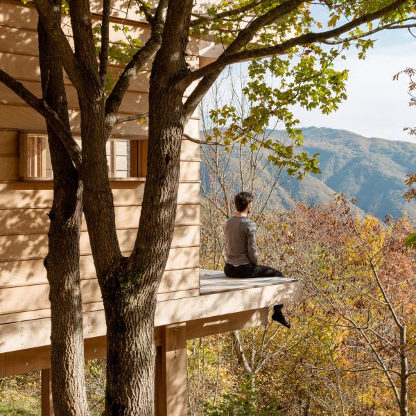 Person on terrace of wooden cabin