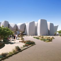 Cluster of white concrete buildings on sand