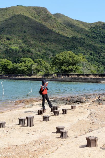 Person looking at Tidal Stools by Hong Kong University