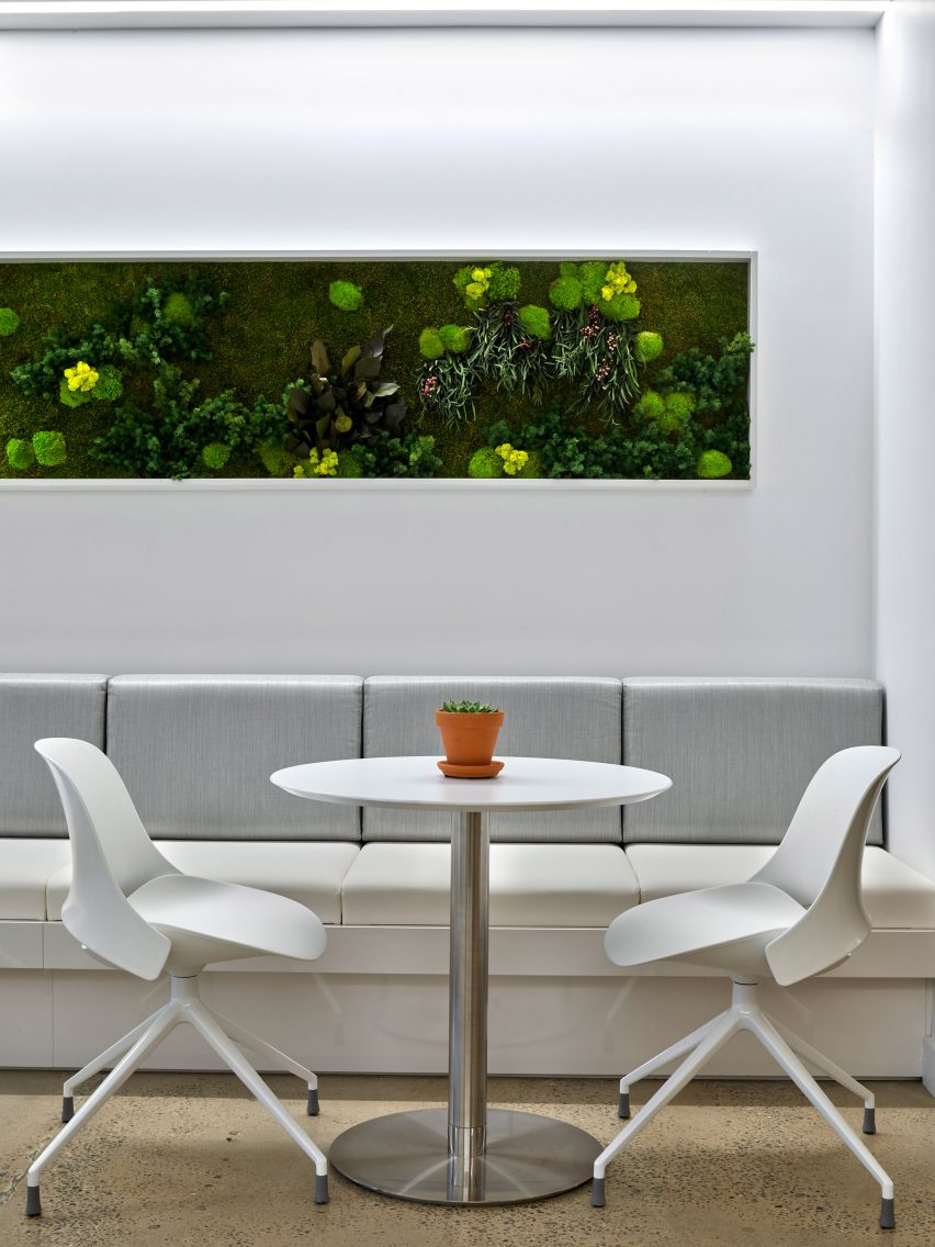 Two white chairs and a round table