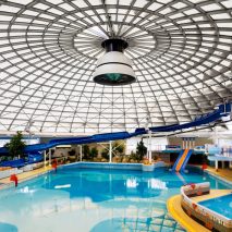 Leisure centre with blue pool under glass roof