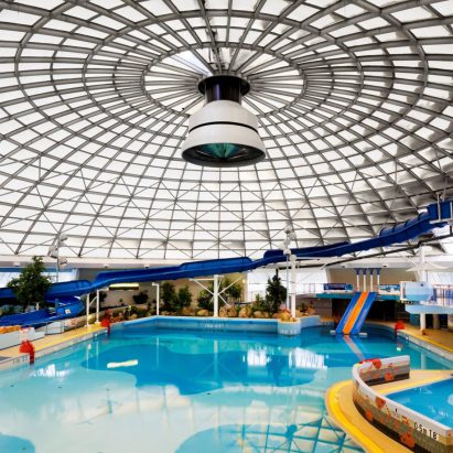 Leisure centre with blue pool under glass roof