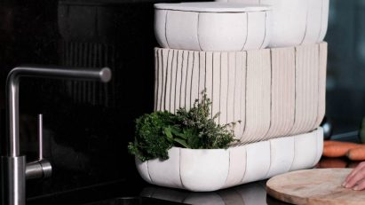 Kitchen sink with white ceramic boxes beside it
