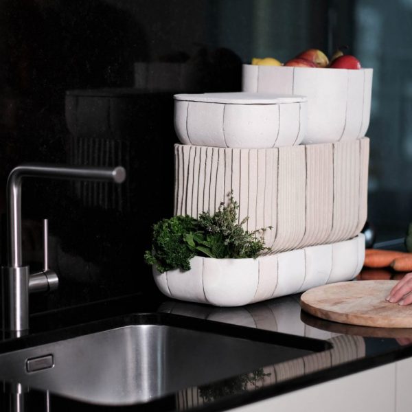 Kitchen sink with white ceramic boxes beside it