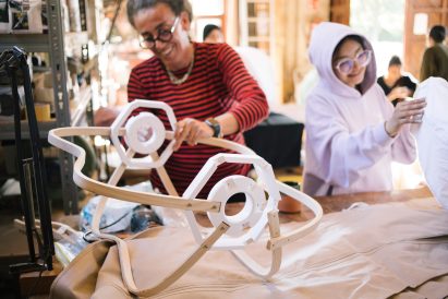 Photograph of people making the installation with wood