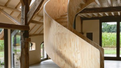 Plywood spiral staircase in Barn at the Ahof by Julia van Beuningen