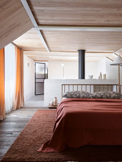 Bedroom suite with red rug and bed spread