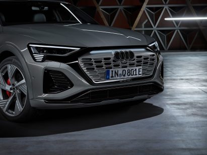 A silver car with the new Audi logo