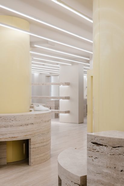 Travertine plinths in store interior by Halleroed