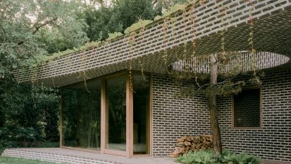 Brick extension opens up Dutch home to forested garden