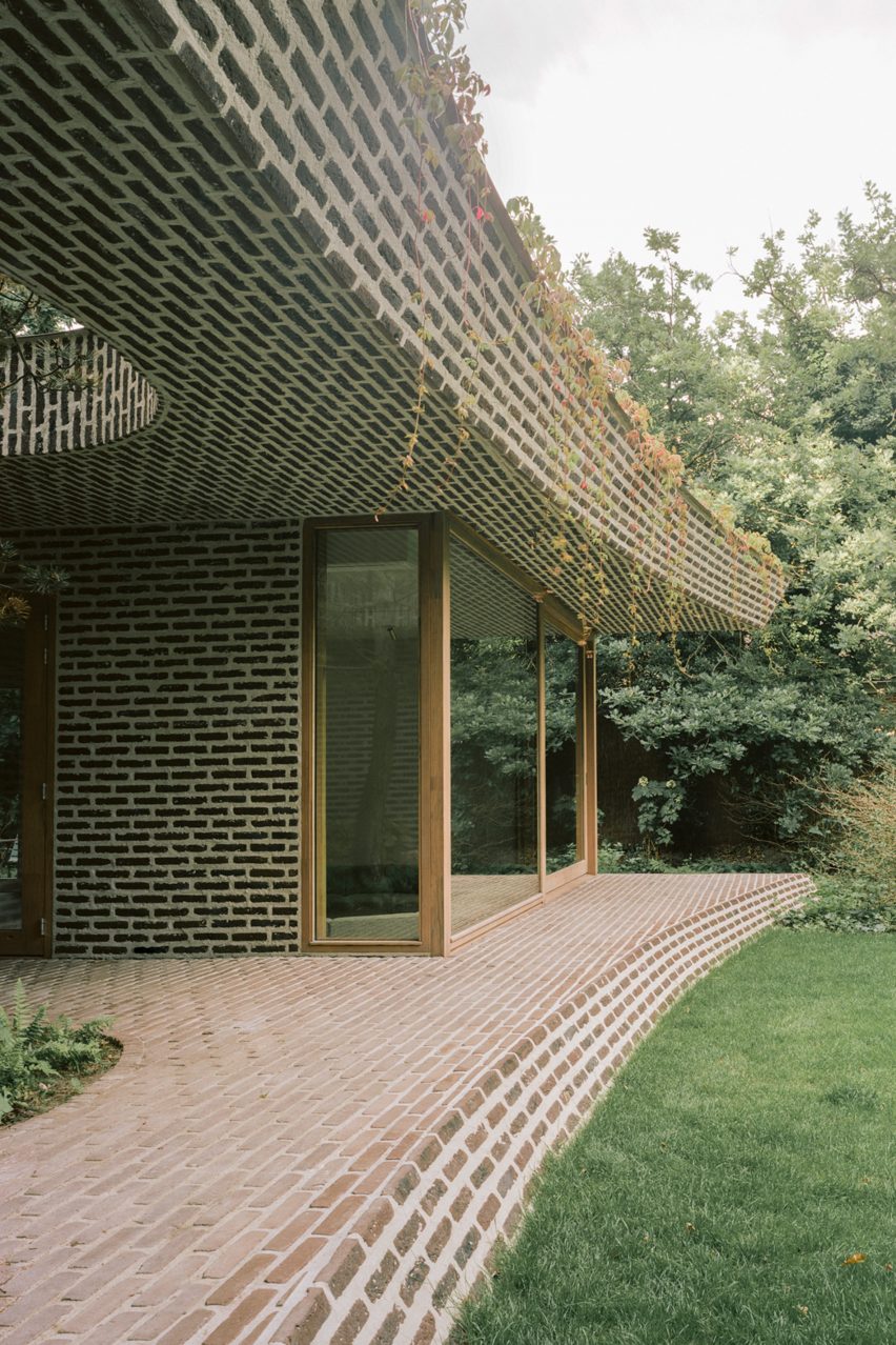 Brick extension opens rural Dutch home out towards a forested garden