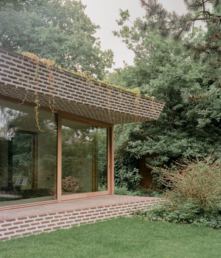 Brick extension opens rural Dutch home out towards a forested garden