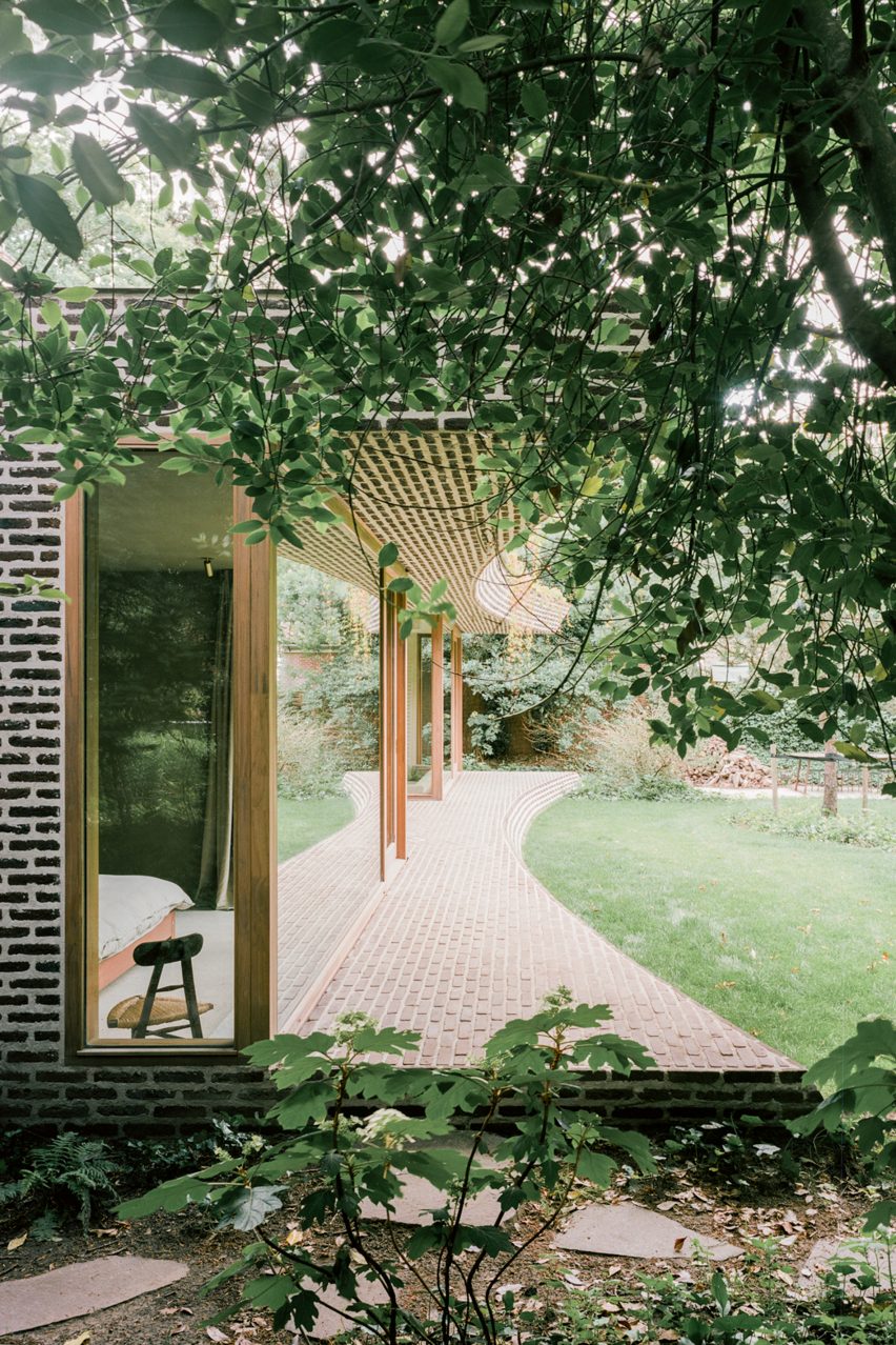 Brick extension opens rural Dutch home out towards a forested garden