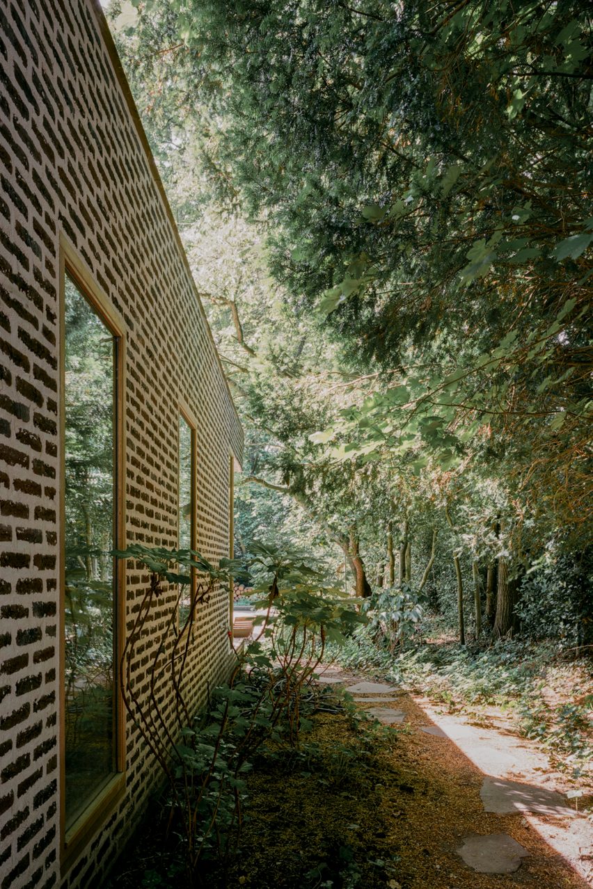Brick extension opens rural Dutch home out towards a forested garden