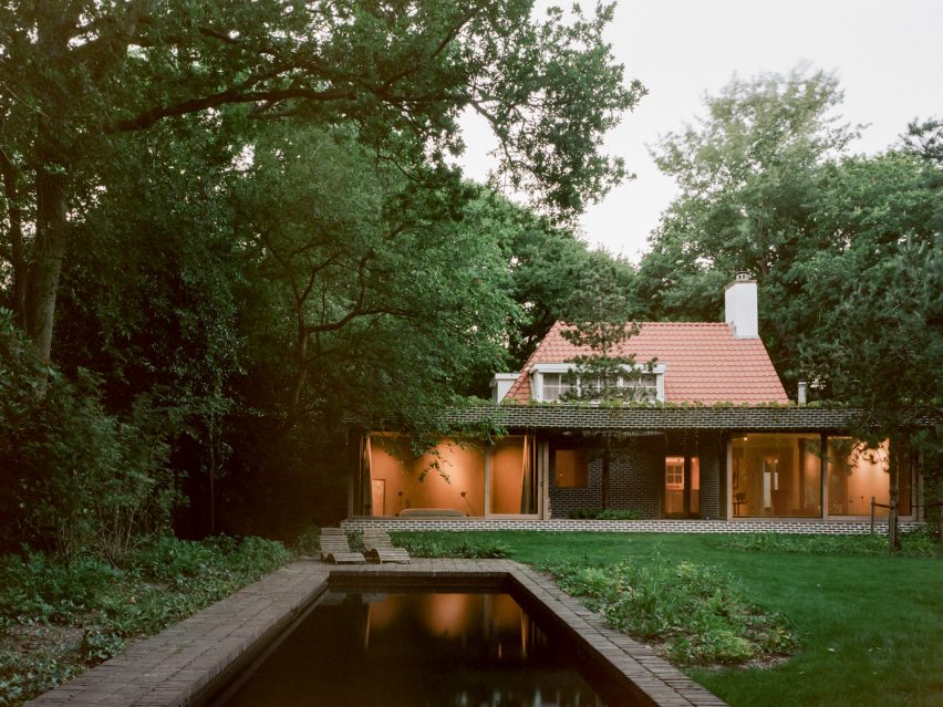 Brick extension opens rural Dutch home out towards a forested garden
