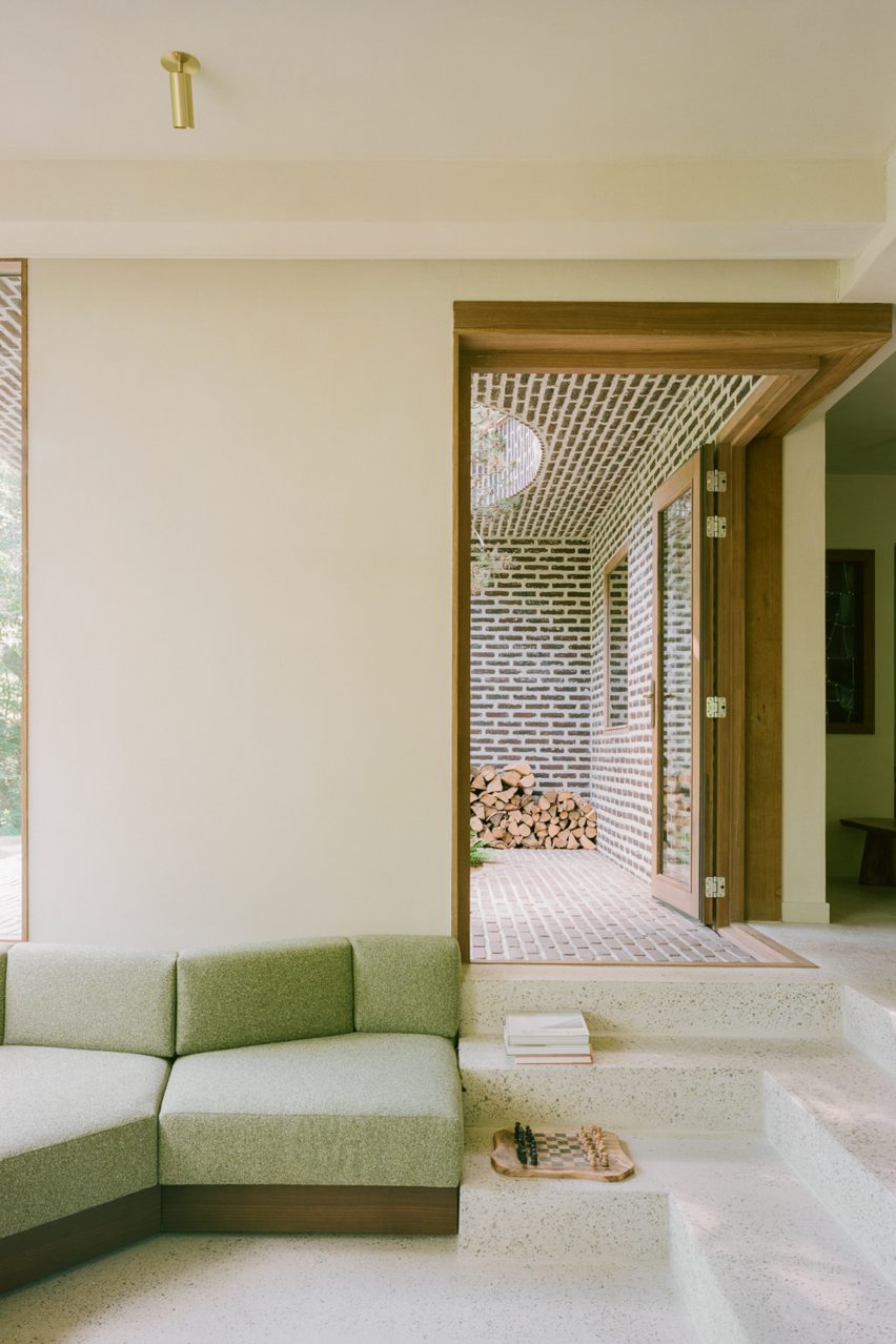 Brick extension opens rural Dutch home out towards a forested garden