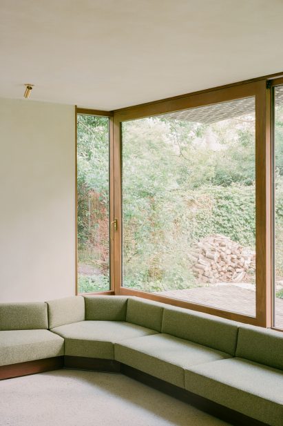 Interior image of a living area with a green sofa at BD House