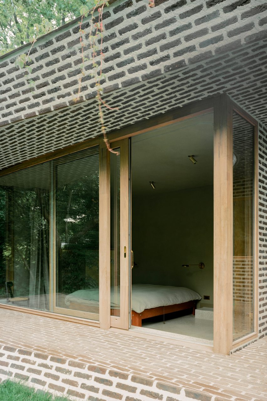 Brick extension opens rural Dutch home out towards a forested garden