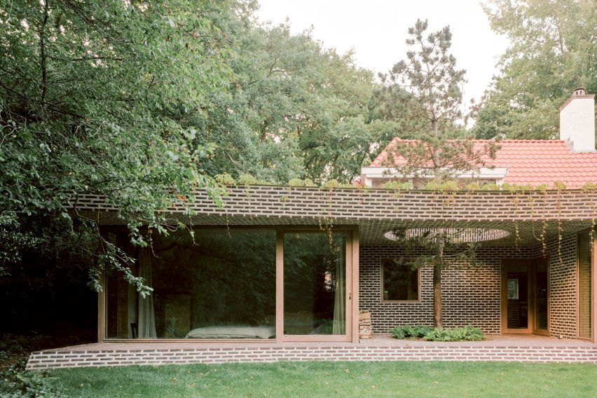 Brick extension opens rural Dutch home out towards a forested garden
