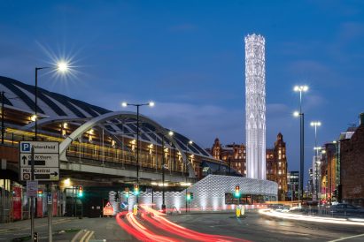 White steel tower against blue night sky