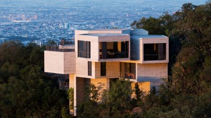 Casa Ventura emerging from the forested hillside