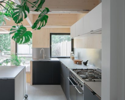Dark kitchen of CLT House by Unknown Works